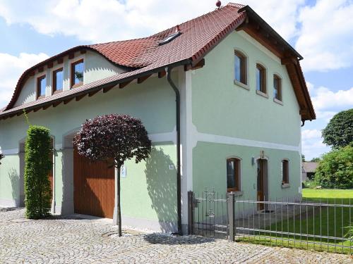 ein kleines Haus mit einem Zaun davor in der Unterkunft Modern Apartment in Eslarn with Lake Near in Eslarn