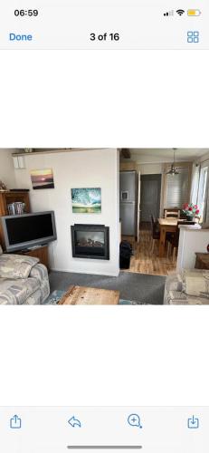 a living room with a couch and a fireplace at Cosy static caravan, hunstanton in New Hunstanton
