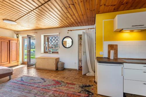 a kitchen with yellow walls and a counter top at Fuchsbau Ferienwohnung am Chiemsee in Seeon-Seebruck