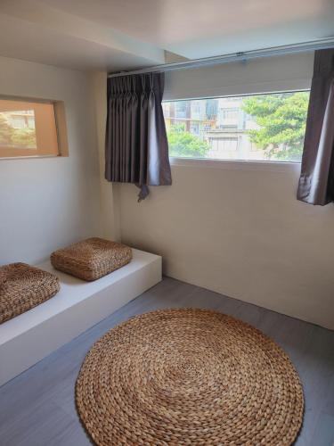 a room with two beds and a large window at Line Bangkok Hostel in Bangkok