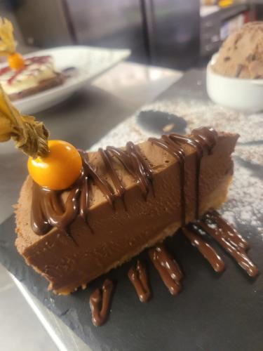 a chocolate dessert with a fruit on top of it at The Blue Bell Inn in Weaverthorpe