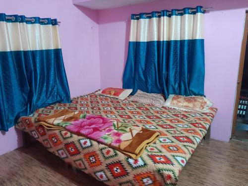 a bedroom with a bed with a colorful comforter at Ram priya plaice 5 mint waking Ram mandir in Ayodhya