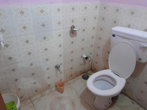 a bathroom with a white toilet in a room at Ram priya plaice 5 mint waking Ram mandir in Ayodhya