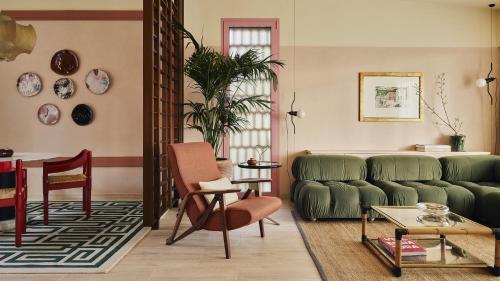 a living room with a green couch and a table at Castello di Casole, A Belmond Hotel, Tuscany in Casole dʼElsa