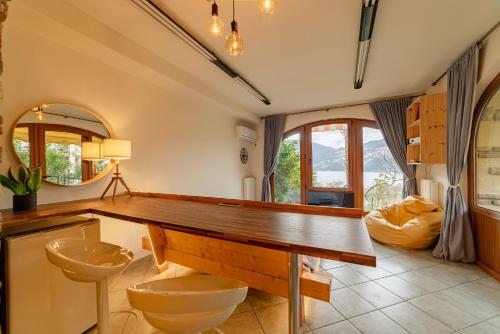 a bathroom with a desk and a toilet and a mirror at Studio with private garden by GardaDoma in Brenzone sul Garda