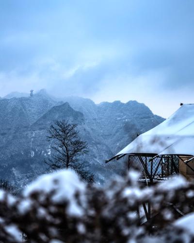 a snow covered view of a mountain with trees and mountains at BZIKA Wonderland Retreat--Zhangjiajie National Forest Park Store in Zhangjiajie