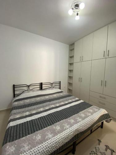 a bedroom with a bed and white cabinets at Rhodes Volkshaus in Afantou