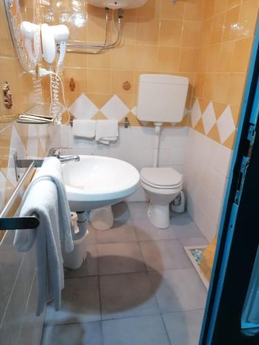 a bathroom with a white toilet and a sink at Dimora Coloniale B&B in Ischia