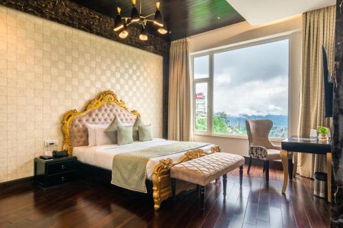 a bedroom with a bed and a large window at The Orchid Shimla in Shimla