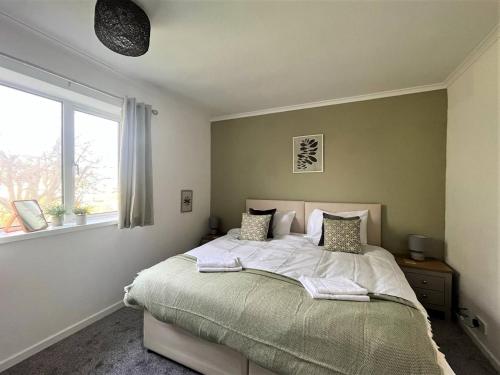 a bedroom with a large bed and a window at Charming 3-bed Home In Bourne in Lincolnshire