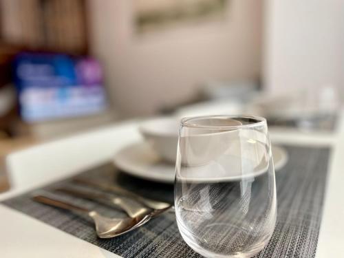 a glass of water sitting on top of a table at Cies Suitel López de Neira 28 - Love your Stay in Vigo