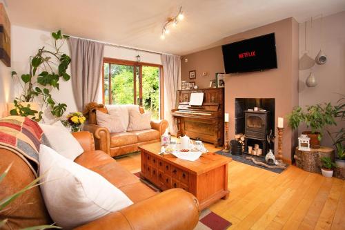 a living room with a couch and a table at Beechwood Lodge Guesthouse in Alness