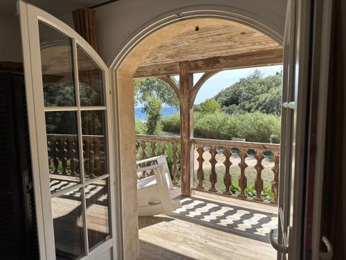 an open door to a balcony with a view at Le Clos des Sept Palmiers in Cavalaire-sur-Mer