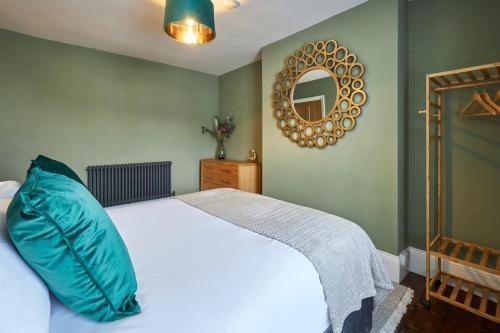 a bedroom with a white bed and a mirror at Host & Stay - Oliver's Den in Alnwick