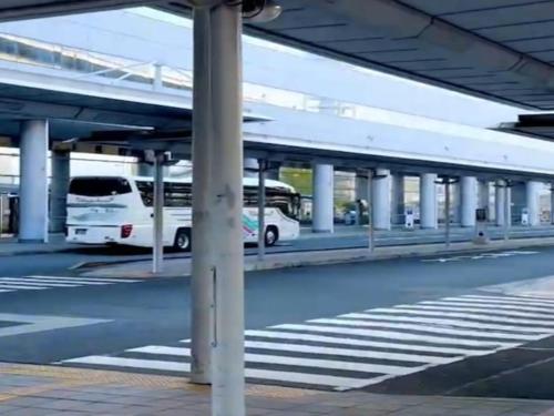 a parking lot with buses parked under a bridge at Kansai Airport Washington Hotel in Izumi-Sano