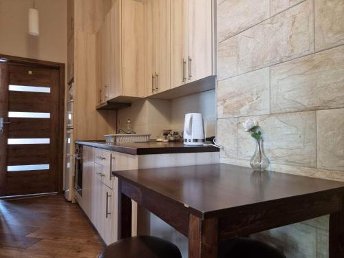 a kitchen with a wooden island in the middle at Cozy rooms in Old Town and Wawel in Kraków