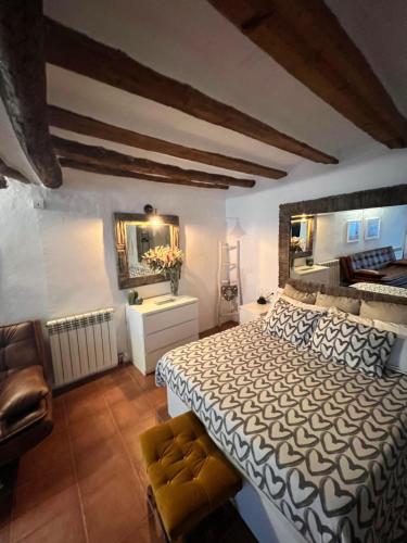 a bedroom with a large bed and a mirror at El Rinconcito in Fuentespalda