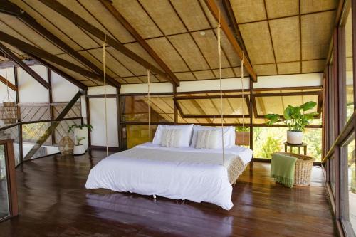 a bedroom with a white bed in a room at Mantaray Siargao in General Luna