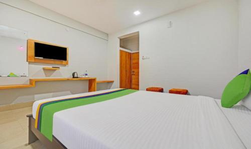a bedroom with a large bed and a tv at Hotel Moody Moon budget friendly stay near igi international airport delhi in New Delhi