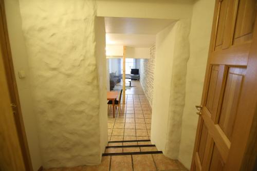 a hallway with a tile floor and a door at Viru Old Town Apartment in Tallinn