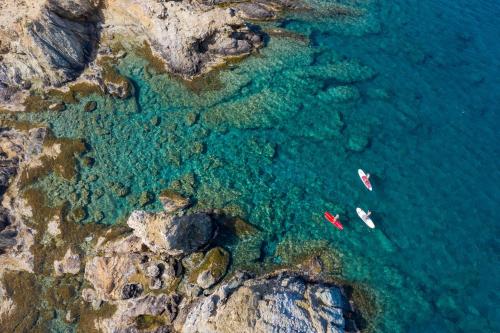 an aerial view of a beach with two boats in the water at Petras sea view apartment - 50 meters from the sea in Sitia