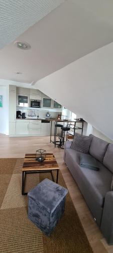 a living room with a couch and a table at Apartment Feodora in Sassnitz