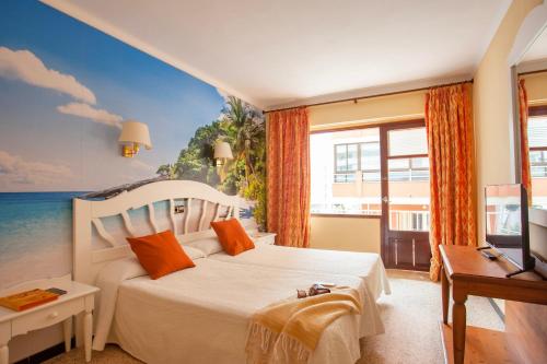 a bedroom with a bed with a view of the ocean at BJ Hostal Bona Vista in S'Illot