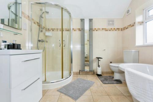 a bathroom with a shower and a toilet and a sink at Modern 3 Bed Home - Solihull Centre in Solihull