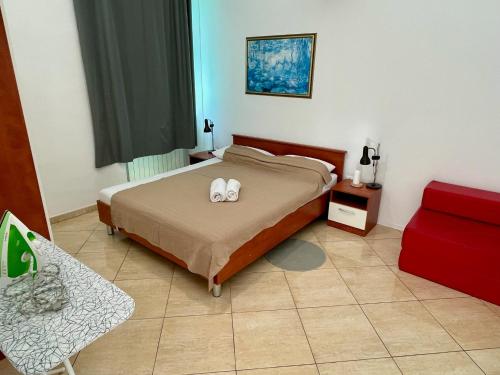 a bedroom with a bed with two white towels on it at Spacious Apartment in Vabriga