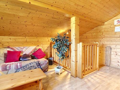 a bedroom with a bed in a wooden cabin at Chalet Les Hotelieres - 8 pers - Proche des pistes in Les Gets