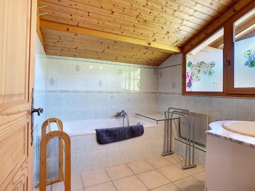 une salle de bain avec une baignoire et un lavabo dans l'établissement Chalet Les Hotelieres - 8 pers - Proche des pistes, aux Gets