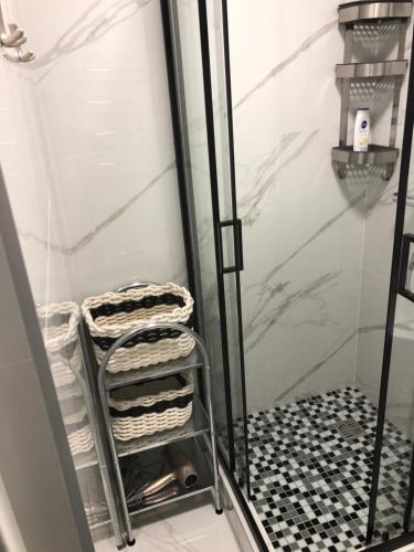 a towel rack in a shower with towels at Pilėnų apartamentai in Panevėžys