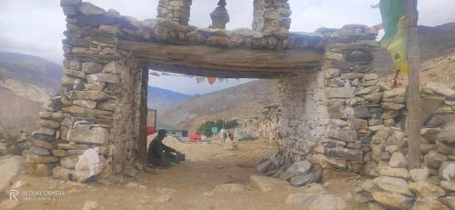 an entrance to a stone building in the mountains at Galaxy Home Stay in Nako