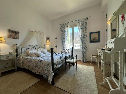 a bedroom with a bed and a desk and a window at Beachfront House Kipri in Kypri