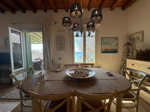 a dining room with a wooden table and chairs at Beachfront House Kipri in Kypri