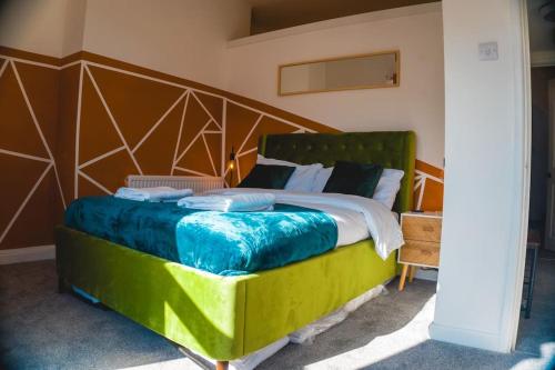 a bedroom with a large bed with a wooden headboard at Perfect Stays in Mutely for Couples in Plymouth