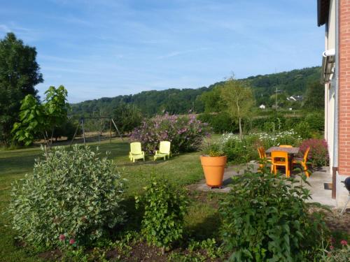 a garden with chairs and a table and a swing at Modern holiday home in Crux La Ville with terrace in Crux-la-Ville
