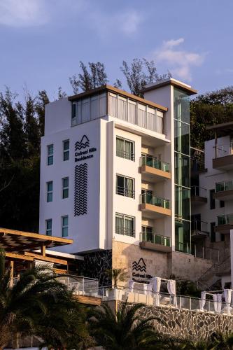 a building with a sign on the side of it at Cofresi Hills Residence in Gurapito