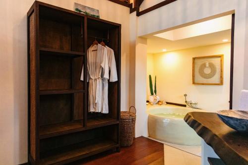a bathroom with a bath tub and a sink at Mantaray Siargao in General Luna