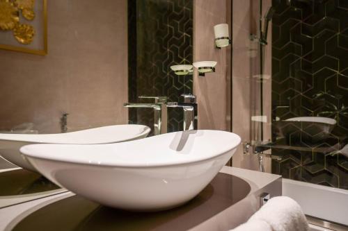 a bathroom with two sinks and a shower at Lux BnB I AG Tower I Canal Views in Dubai