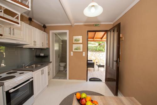 a kitchen with a bowl of fruit on a table at Astrakeri Sea Side Hill in Astrakeri