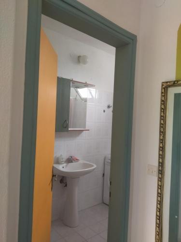 a bathroom with a sink and a toilet and a mirror at AGAPI'S HOUSE in Sidhirókastron