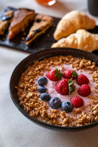 a pie with berries and whipped cream in a bowl at Hotel Des Alpes in Cortina dʼAmpezzo