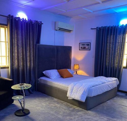 a bedroom with a large bed with blue lighting at Kath's Hub in Lagos