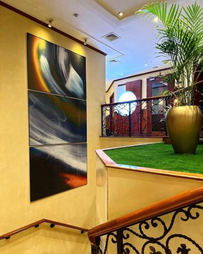 a balcony with a large vase on the wall at Marco Polo Hotel in Dubai