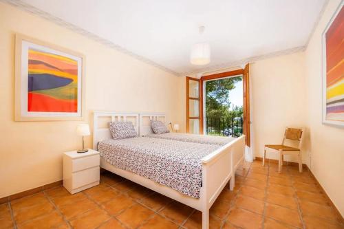 a bedroom with a white bed and a window at CalaPi One vistas Mar. in Cala Pi