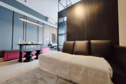 a bedroom with a bed and a table in it at Axon Bukit Bintang_Studio (B) in Kuala Lumpur