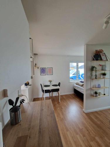 a living room with a table and a couch at Lækker lejlighed in Copenhagen