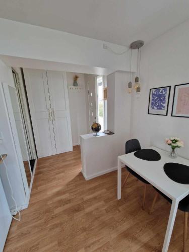 a living room with a white table and a dining room at Lækker lejlighed in Copenhagen