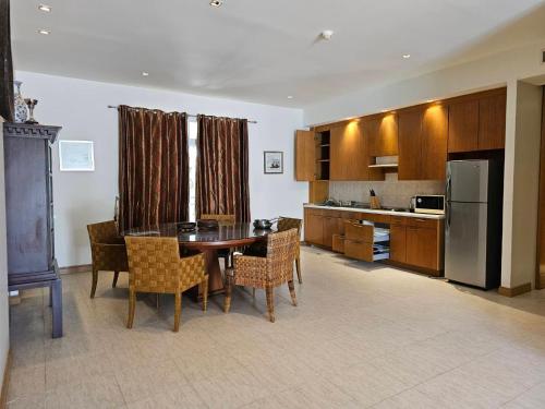 a kitchen with a table and chairs and a refrigerator at Hua Hin Blue Lagoon in Cha Am